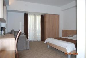 a hotel room with a bed and a couch at Kompleks Negorski Banji in Gevgelija