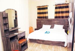 a bedroom with a bed and a large mirror at Immaculate 2-Bed Apartment in Idimu in Idimu