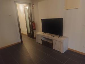 a living room with a flat screen tv on a table at Aldea Bricia 201 in Posada de Llanes