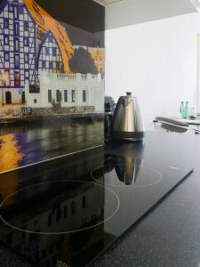 a kitchen counter with a tea kettle on top of it at Softly Residence in Bydgoszcz