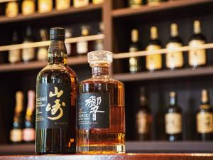 a bottle of whisky sitting on a table next to a glass at Kumonoue Fuji Hotel - Vacation STAY 13709v in Oishi