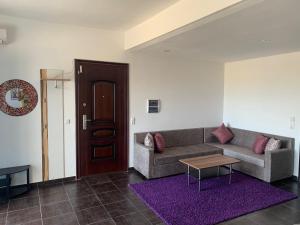 a living room with a couch and a table at Luxus Apartments in Kelibia