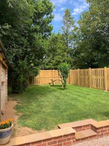a backyard with a wooden fence and a bench at Lazy Acres Annex in Langtree