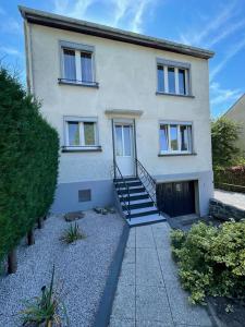 a white house with a staircase in front of it at Les Balcons de la Vallée in Haybes +9 photos
