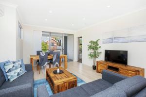 a living room with a couch and a table and a tv at 134 North Perth Nest For 4 Parking in Perth
