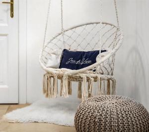a white swing chair with a pillow in a room at NEW Design & High Standard Apt from 16th Century in Old Town in Bratislava
