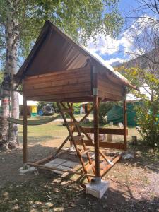 a smallshed with a roof on top of it at Le bivouac-tente chez Camille in Veynes +7 photos