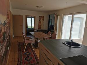 a kitchen and dining room with a table and chairs at Schöne große 90 m² Ferienwohung in Zweikirchen in Zweikirchen +3 photos