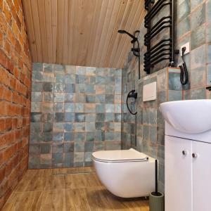 a bathroom with a toilet and a sink at Pieninė in Ventė