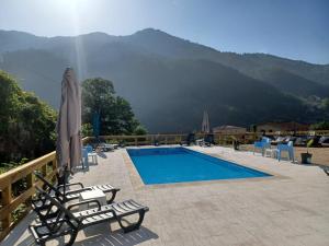 a swimming pool with a view of a mountain at Waterfalls Gerês AL in Geres