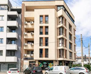 a tall building with cars parked in front of it at Central Studio Bucur in Bucharest