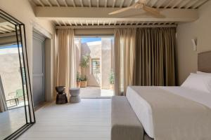 a bedroom with a bed and a balcony at AZADE Chania in Chania