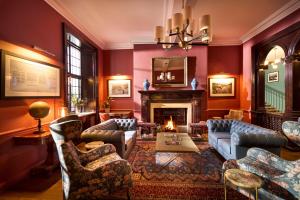 a living room filled with furniture and a fireplace at Royal Marine Hotel in Brora