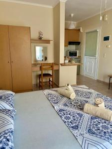 a bedroom with a large bed with towels on it at Theodora’s Studios 2 in Repanídhion +23 photos