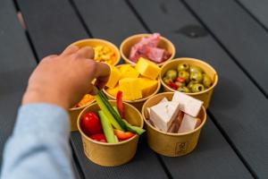 a child is putting food into containers of food at Europarcs Koningshof in Schoorl