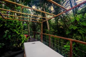乌布Villa La Canopée by BaliSuperHost的丛林中带白色长凳的阳台