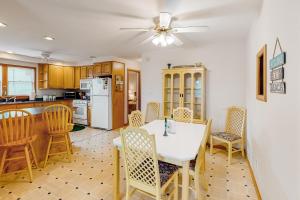 a kitchen and dining room with a table and chairs at AVHC23 Beach Box in Avon