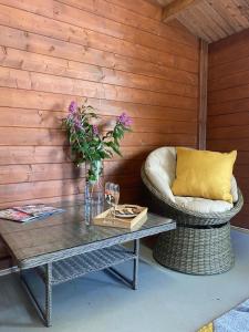 a coffee table with a chair and a couch at Lazy Acres Annex in Langtree