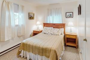 a bedroom with a bed with two night stands and two lamps at AVHC23 Beach Box in Avon