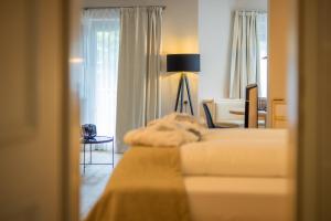 a hotel room with two beds and a lamp at MANNI das Hotel in Mayrhofen