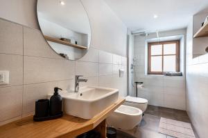 a bathroom with a sink and a toilet and a mirror at Sparberhof Apt Antonius in Campo di Trens