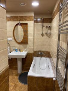 a bathroom with a sink and a bath tub at Yerevan City Center apartment in Yerevan