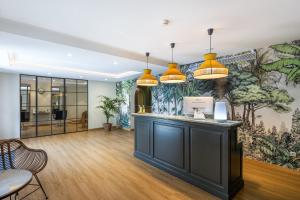 a lobby with a large mural on the wall at Hotel LIVVO Volcán Lanzarote in Playa Blanca +37 photos
