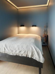 a bedroom with a large white bed with two lights at Koie Deluxe I in Stranda