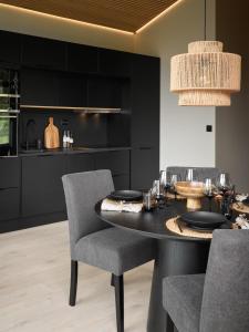 a dining room with a black table and chairs at Koie Deluxe in Stranda