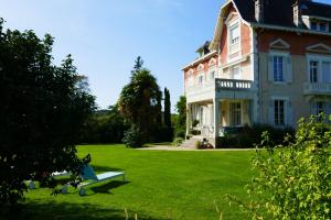 a large house with a lawn in front of it at Domaine de Bassilour in Bidart