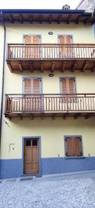 un edificio con puertas de madera y balcones. en Altopiano del sole, en Lozio