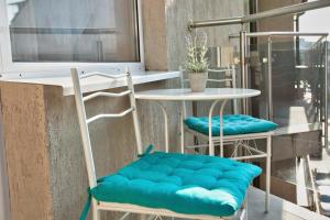 two chairs with blue cushions sitting next to a table at ❀ AURORA-AN OASIS IN VIBRANT DOWNTOWN! ❀ A/C, LIFT in Sofia