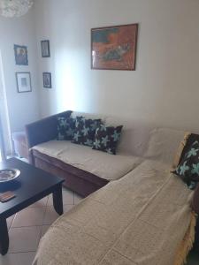 a living room with a couch and a table at Dream Nikiti xalkidikis in Nikiti