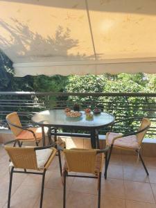 a table and chairs sitting on a balcony with a table and chairs at Dream Nikiti xalkidikis in Nikiti