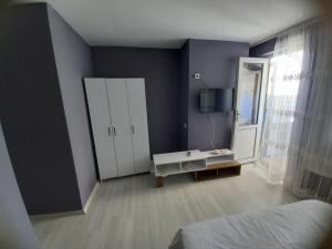 a bedroom with a mirror and a white cabinet at Dilmac Hotel in Gelibolu