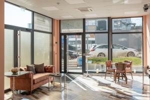 a lobby with a couch and chairs and a car outside at WOW studios for rent 2 bul Montevideo 25A - B in Sofia