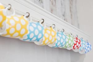 a group of cloth bags hanging on a door at The Cheesery in Chinley