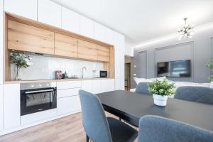 una cucina e un soggiorno con tavolo e sedie di Brioni Flat a Oradea