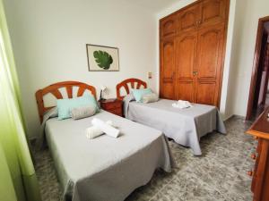 a bedroom with two beds with towels on them at Beach View House in Famara