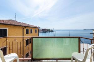 a balcony with a view of the water at Garda Sol SPA Hotel & Appartamenti in Toscolano Maderno