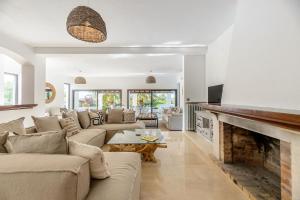 a living room with a couch and a fireplace at Villa Can Ravi in Cala de Bou