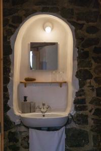 a bathroom with a sink and a mirror on a wall at Mas rural El Negre in Ogassa
