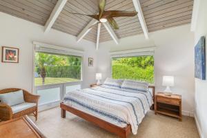 a bedroom with a bed and a ceiling fan at Makana Nui home in Hanalei