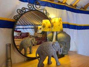 a statue of an elephant next to a mirror at Eco Yourte Les Airelles in Saint-Anthème