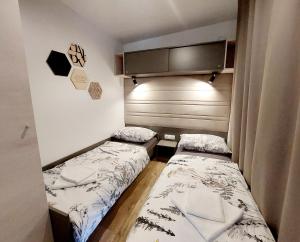 two beds in a small room next to each other at Mobile Home Mar Vista Selce in Selce +47 photos