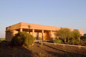 a large building with trees in front of it at MARIS Apartments & Bedrooms in Alghero