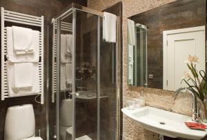 a bathroom with a glass shower and a sink at Hotel Puerta Gamboa in Vigo