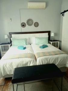 two beds sitting next to each other in a bedroom at B&B 464 on 22nd Ave in Pretoria