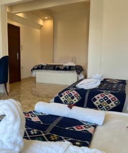 a living room with two beds and a couch at Pyramids Top Inn in Cairo