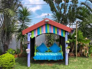 a colorful gazebo with a bed in a yard at Jozini Guesthouse in Jozini